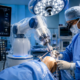 Orthopedic surgeon performing robotic knee replacement surgery in a modern operation theatre with advanced robotic-assisted technology and 3D knee imaging.